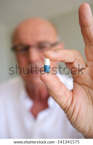 Elderly man taking his medication