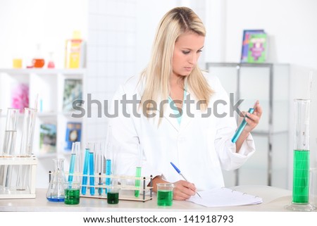 Blonde researcher with test tubes