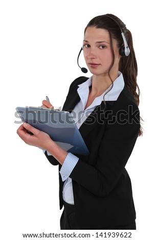 Brunette call-center worker writing on clip-board