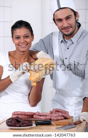 a butcher and his wife/assistant - stock photo