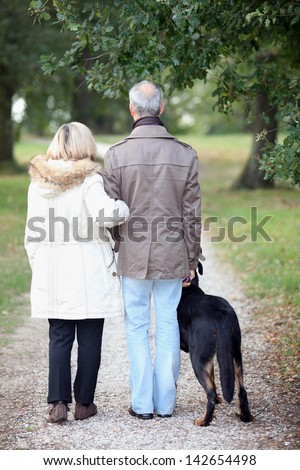 Senior people having a walk with dog