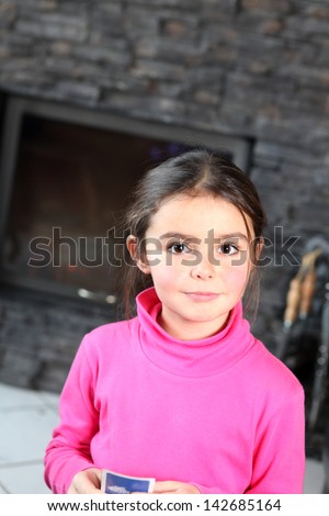 Little girl playing card game alone
