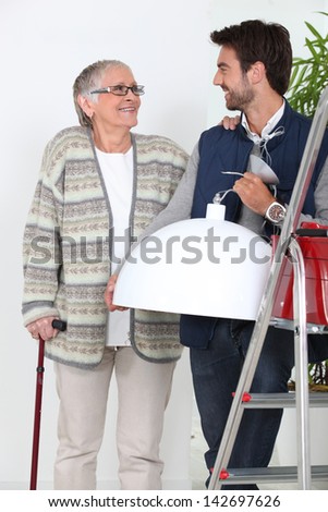 young man helping older woman
