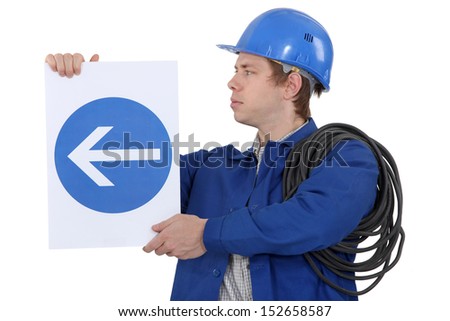 Electrician with a road sign