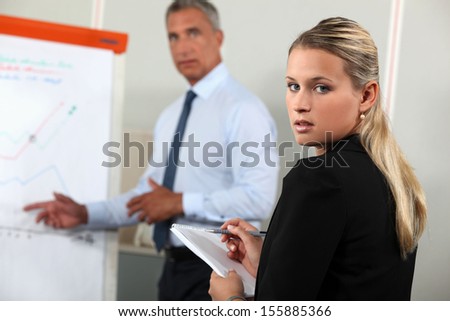 Boss giving presentation via flip-chart