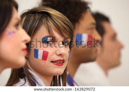 Friends watching the French team play a soccer game