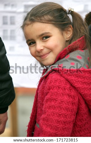 Little girl wearing red coat