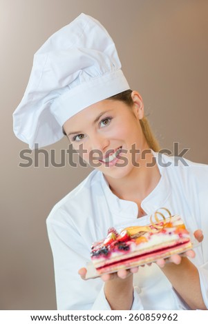 Female bakery chef with a fruit cake