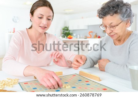 Elderly woman playing a board game