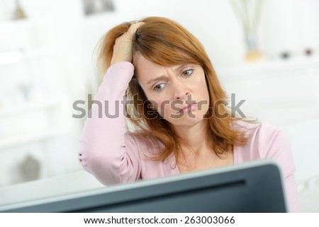 Stressed woman looking at her computer screen