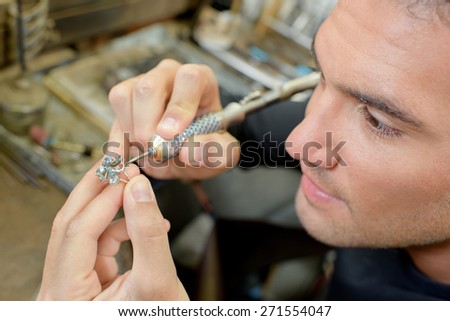 Skilled jeweller repairing a ring