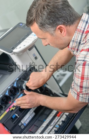 Man repairing a printer