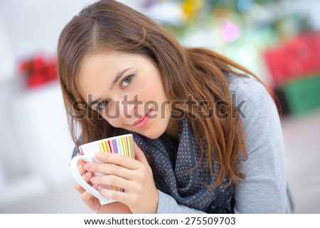 Woman laying on the floor with a cup of coffee