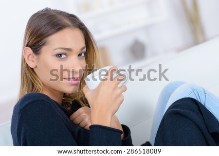 Woman having a nice coffee on the sofa
