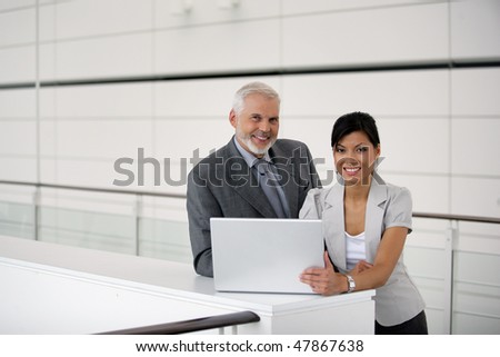business partners working on a project in a company hall