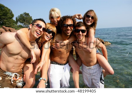Group of friends having fun at the beach