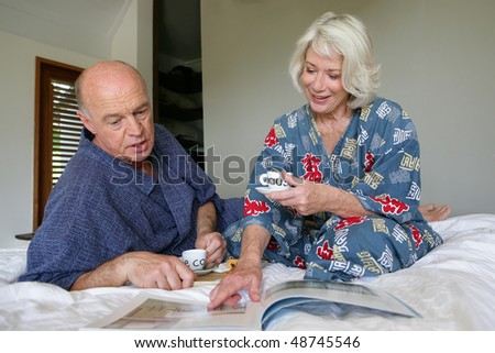 Senior couple having breakfast in bedroom