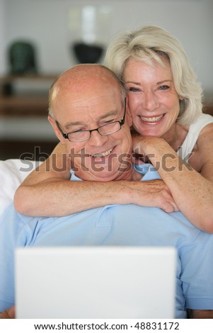 Senior couple with computer at home