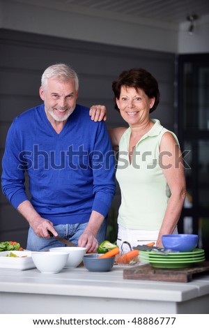 Senior couple cooking at home