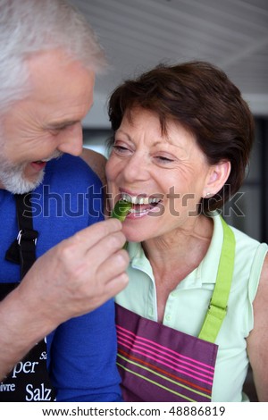 Portrait of senior couple eating vegetables