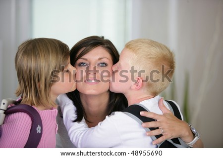 Children kissing their mother goodbye