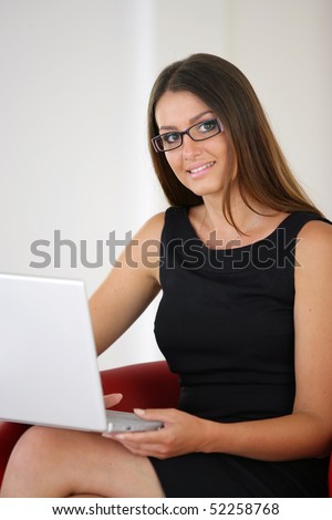 Portrait of a smiling woman in front of of a laptop computer