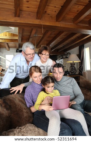 Men and women with a little girl in front of a portable dvd player