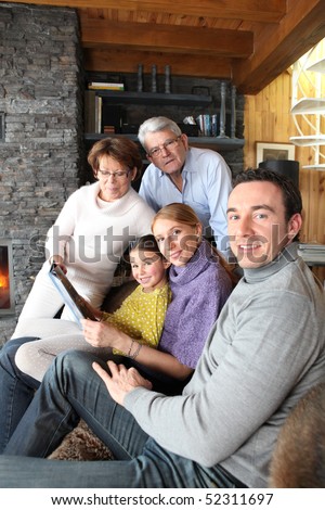 Men and women with a little girl in front of a portable dvd player