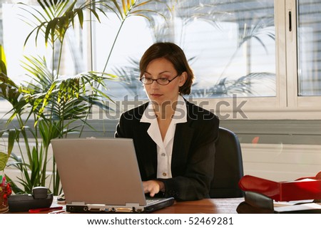 portrait of a woman in front of a laptop computer