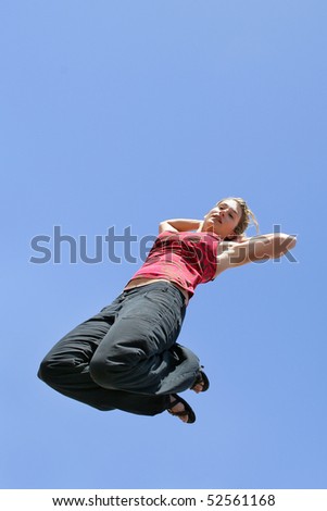 Woman jumping in the air with arms up