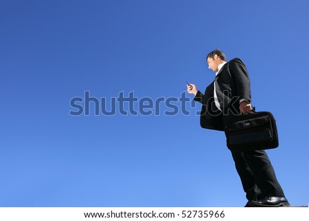 Businessman with a suitcase and a phone