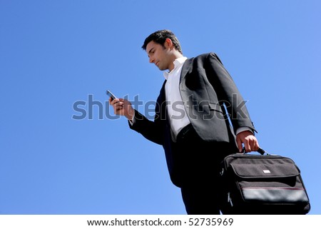 Businessman with a suitcase and a phone