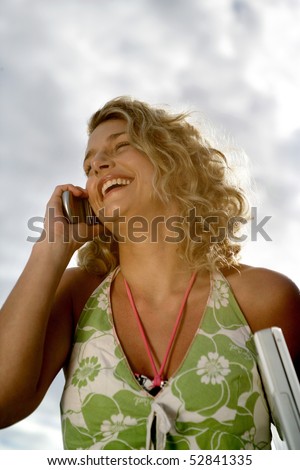 Portrait of a woman laughing at phone