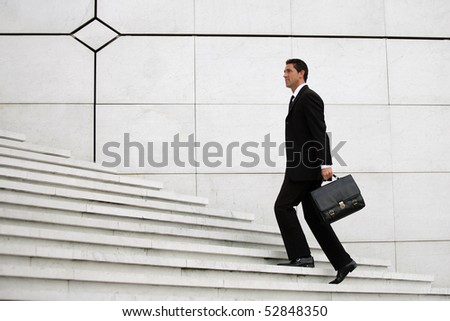 Man with a suitcase lifting stairs