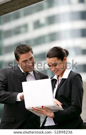 Portrait of smiling man and woman with a laptop computer