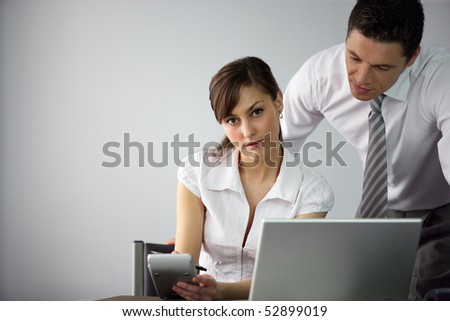 Portrait of a man and a woman in front of a laptop computer