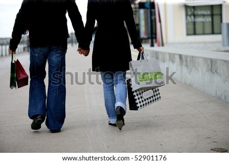 Couple walking with bags