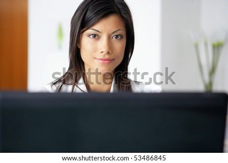 Portrait of a young woman in front of a computer