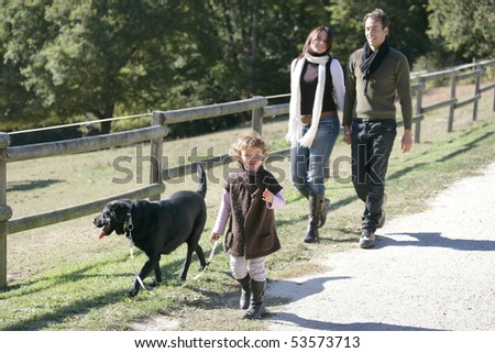 A family having a walk with a dog