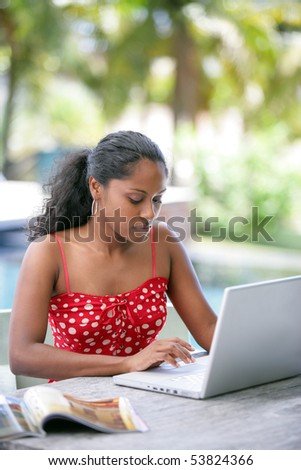 Portrait of a young woman in front of a laptop computer