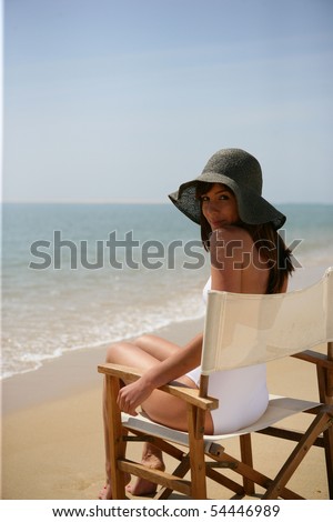 Woman sitting in a folding chair at the beach