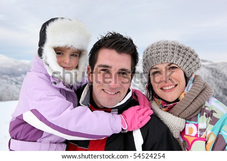 Portrait of a family at the snow