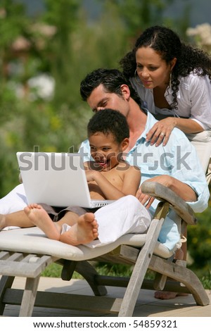 Portrait of a family in front of a laptop computer