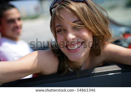 Portrait of a smiling woman inside a car