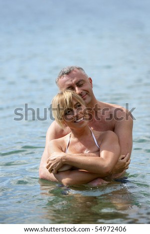 Portrait of a smiling couple bathing in the sea