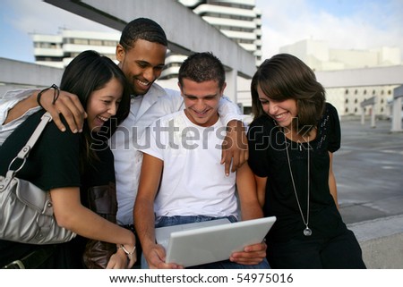 Group of friends with a laptop computer
