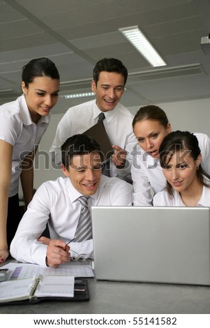 Young business people meeting in front of a laptop computer