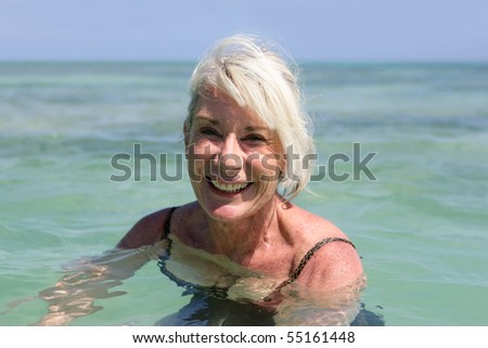 Portrait of a senior woman smiling bathing in the sea