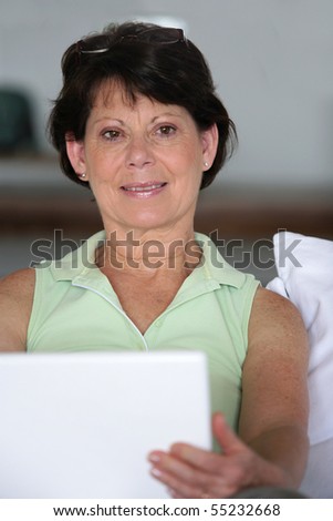 Portrait of a senior woman in front of a laptop computer