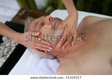 Portrait of a senior man being massaged
